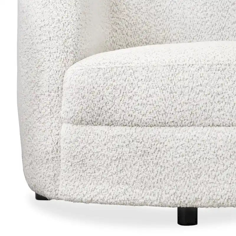 Canapé en bouclé moderne à accoudoirs courbés, assise en forme de rein et pieds ronds en bois