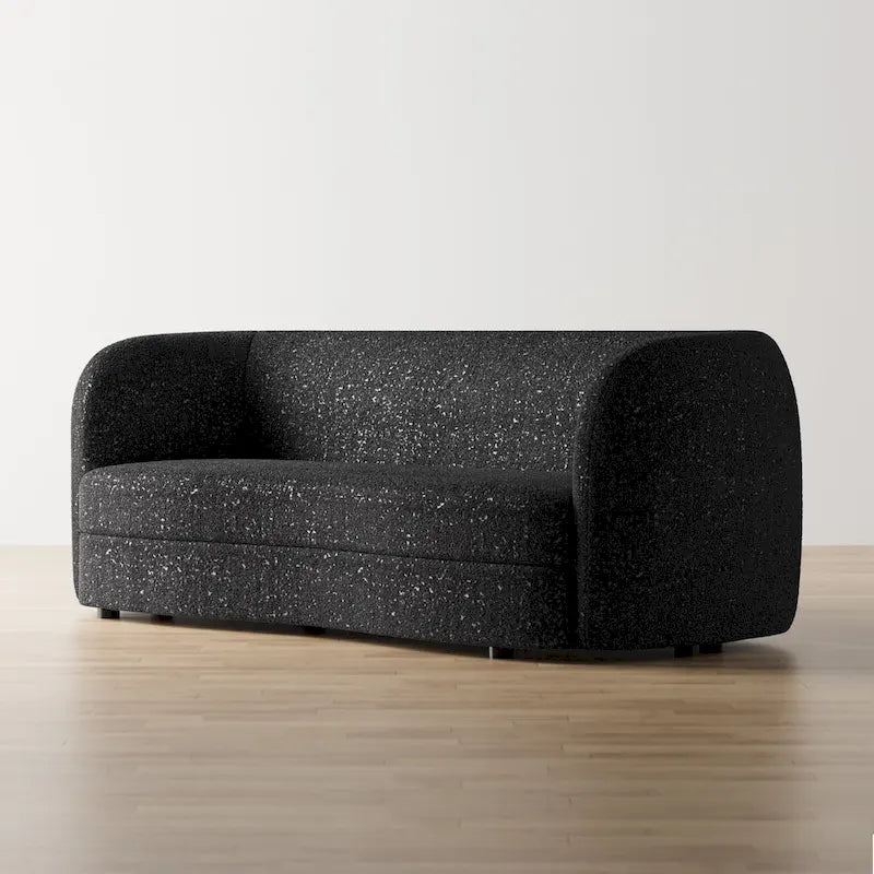 Canapé en bouclé moderne à accoudoirs courbés, assise en forme de rein et pieds ronds en bois